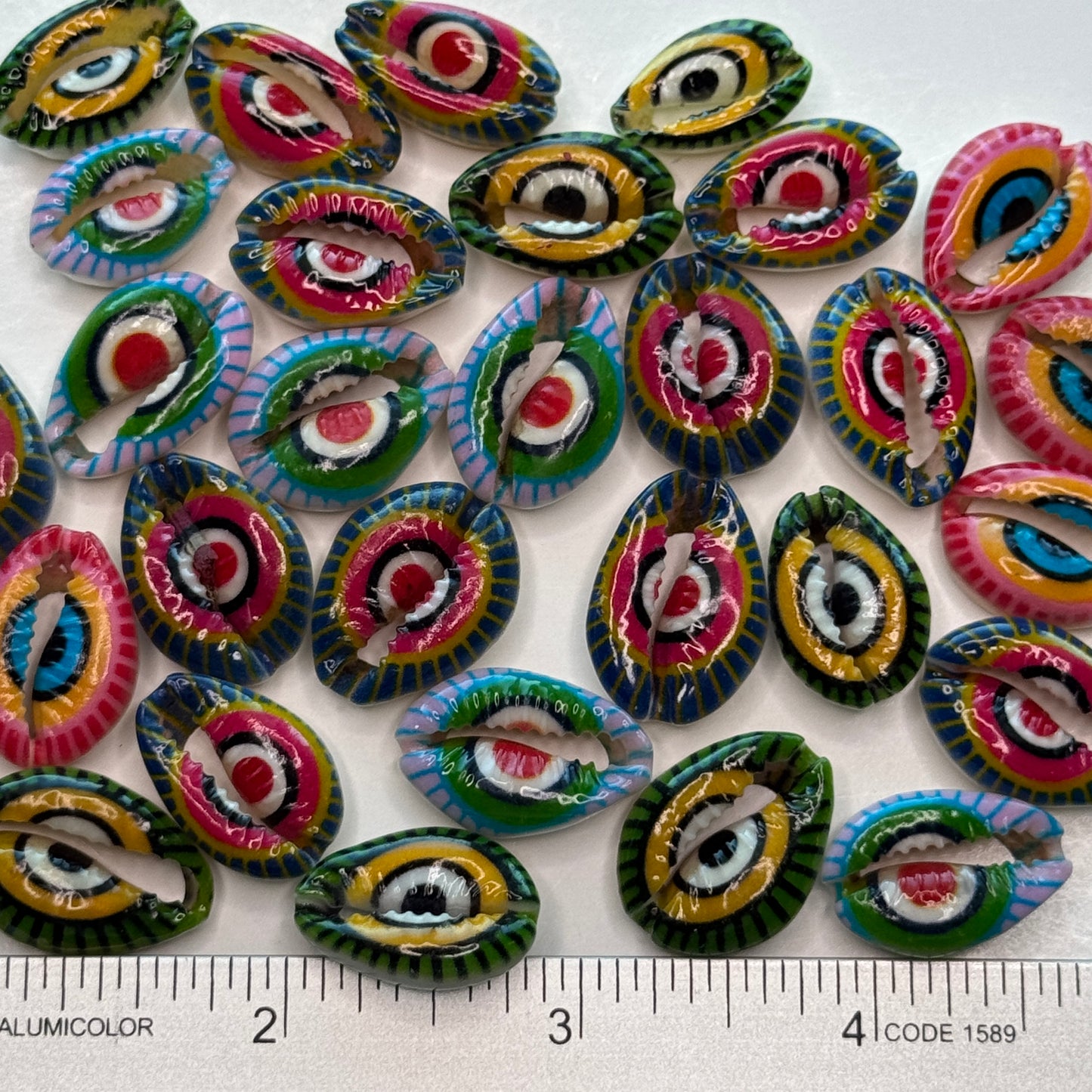 Center cut painted cowrie shells, colorful designs on cut cowrie shells, seashell jewelry, seashell crafts
