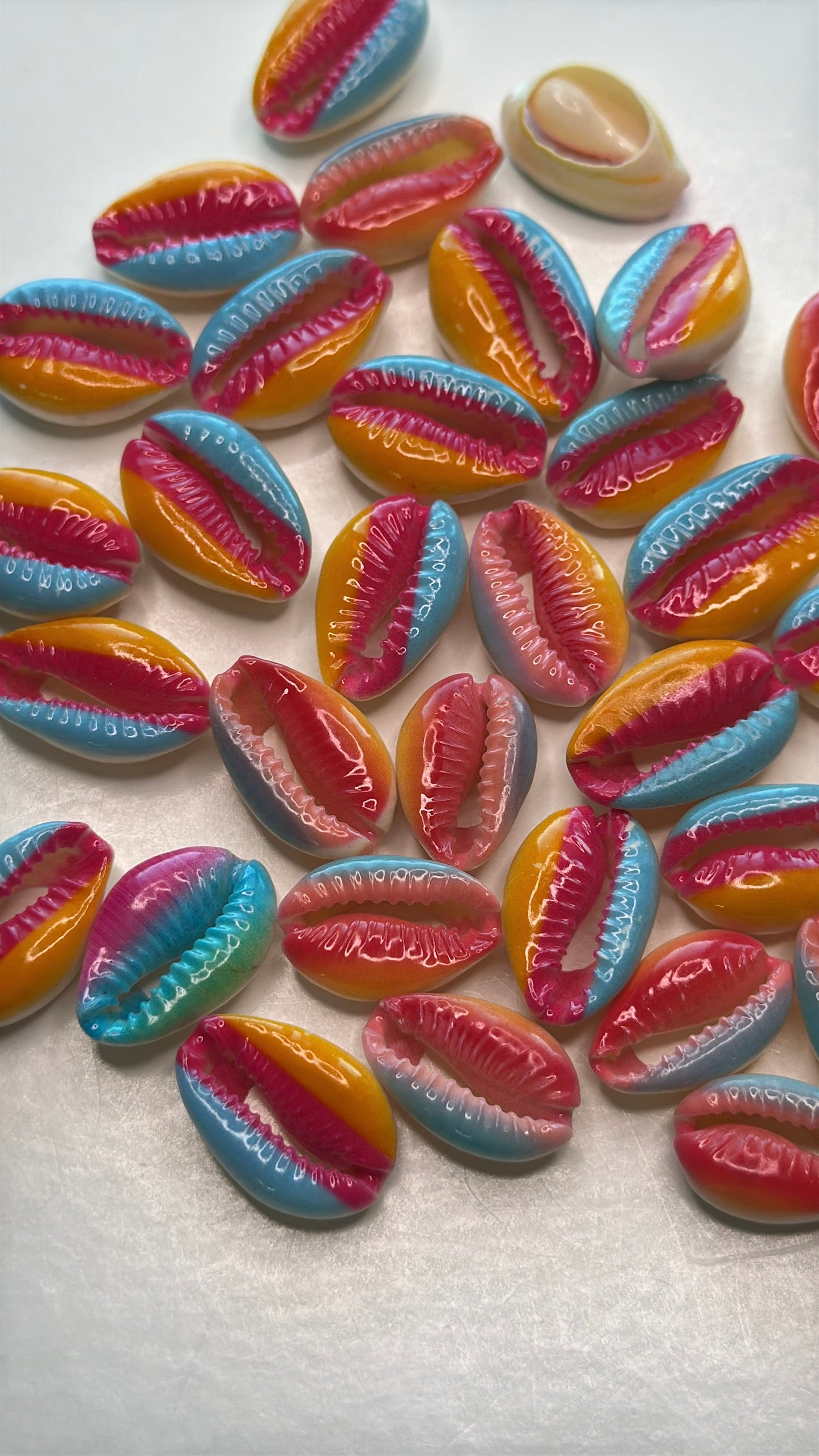 Center cut painted cowrie shells, colorful designs on cut cowrie shells, seashell jewelry, seashell crafts