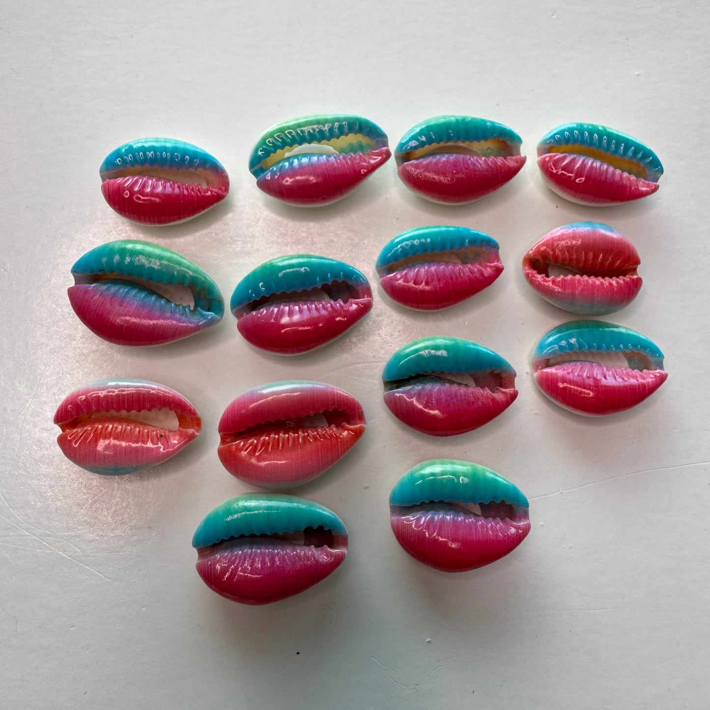 Center cut painted cowrie shells, colorful designs on cut cowrie shells, seashell jewelry, seashell crafts