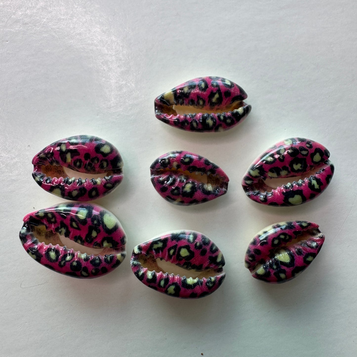 Center cut painted cowrie shells, colorful designs on cut cowrie shells, seashell jewelry, seashell crafts