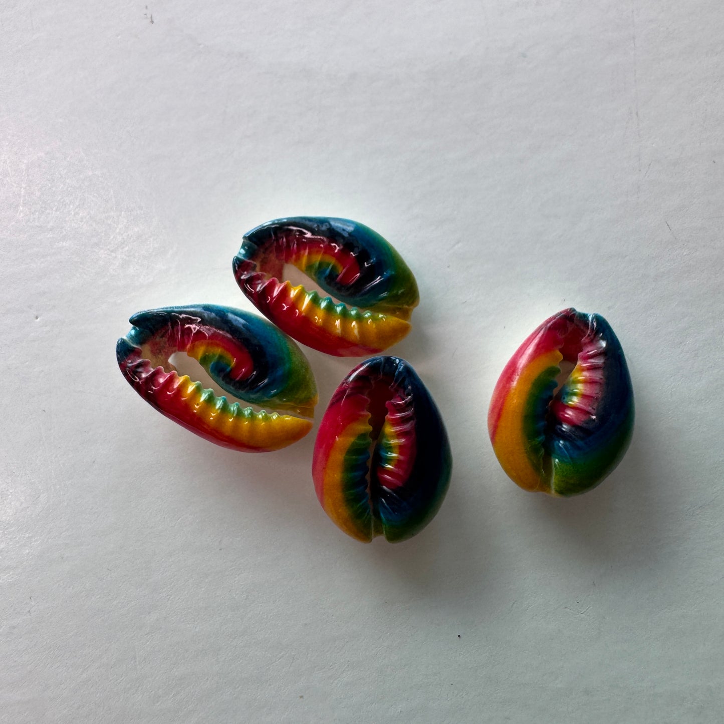 Center cut painted cowrie shells, colorful designs on cut cowrie shells, seashell jewelry, seashell crafts