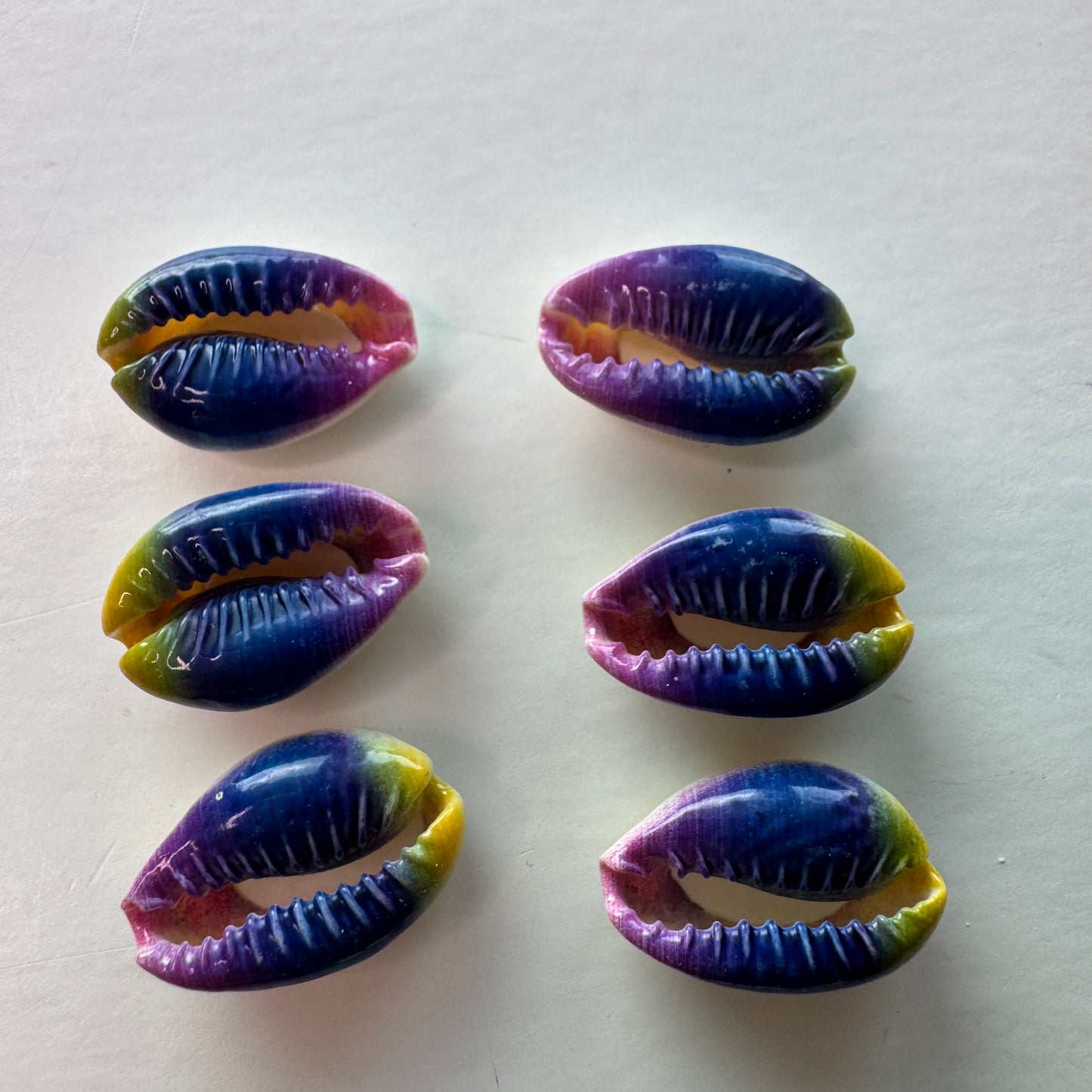 Center cut painted cowrie shells, colorful designs on cut cowrie shells, seashell jewelry, seashell crafts